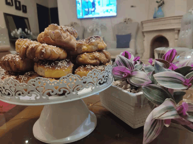 a display of pastries sits on a table in front of a television