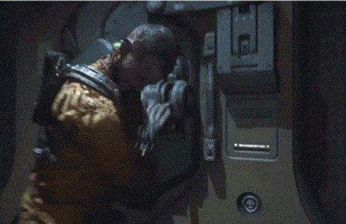 a man with a beard is touching a metal object with his finger