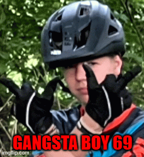 a man wearing a helmet and gloves has the words gangsta boy 69 on his face