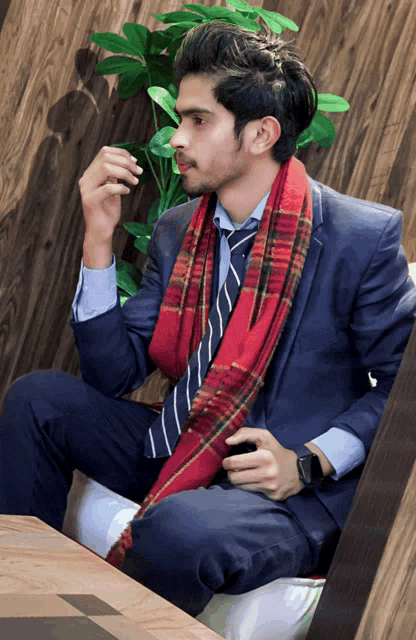 a man in a suit and tie is sitting on a chair