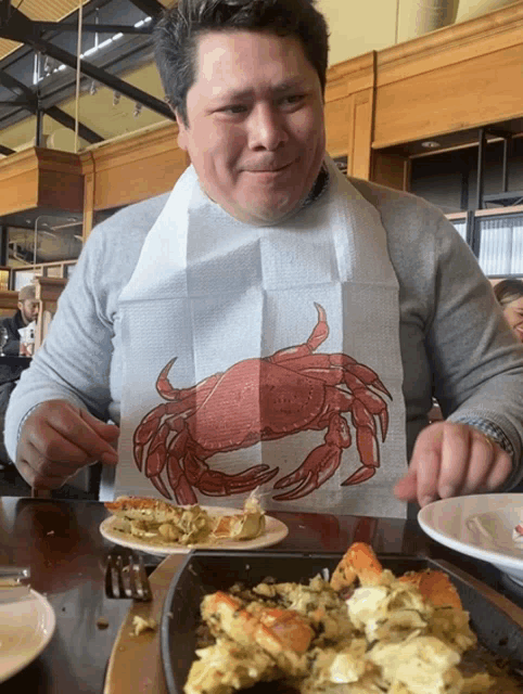 a man is wearing a bib with a crab on it