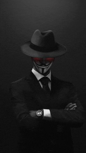 a man in a suit and tie with a anonymous mask on his face