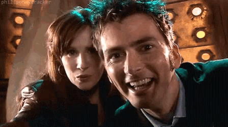 a man and a woman are posing for a picture and smiling for the camera