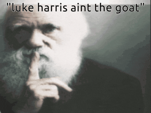 a man with a beard holds his finger to his lips and says " luke harris ain t the goat "