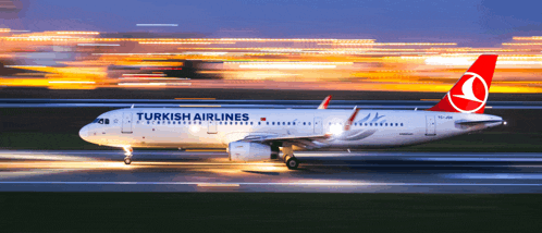 a turkish airlines plane is taking off from an airport runway