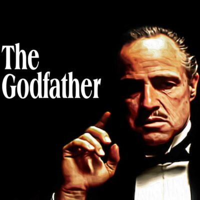 A man in a tuxedo with a stern expression raises his hand near his face. The black background is reminiscent of the iconic scenes from the Godfather movie, where powerful godfather quotes about family echo profoundly.