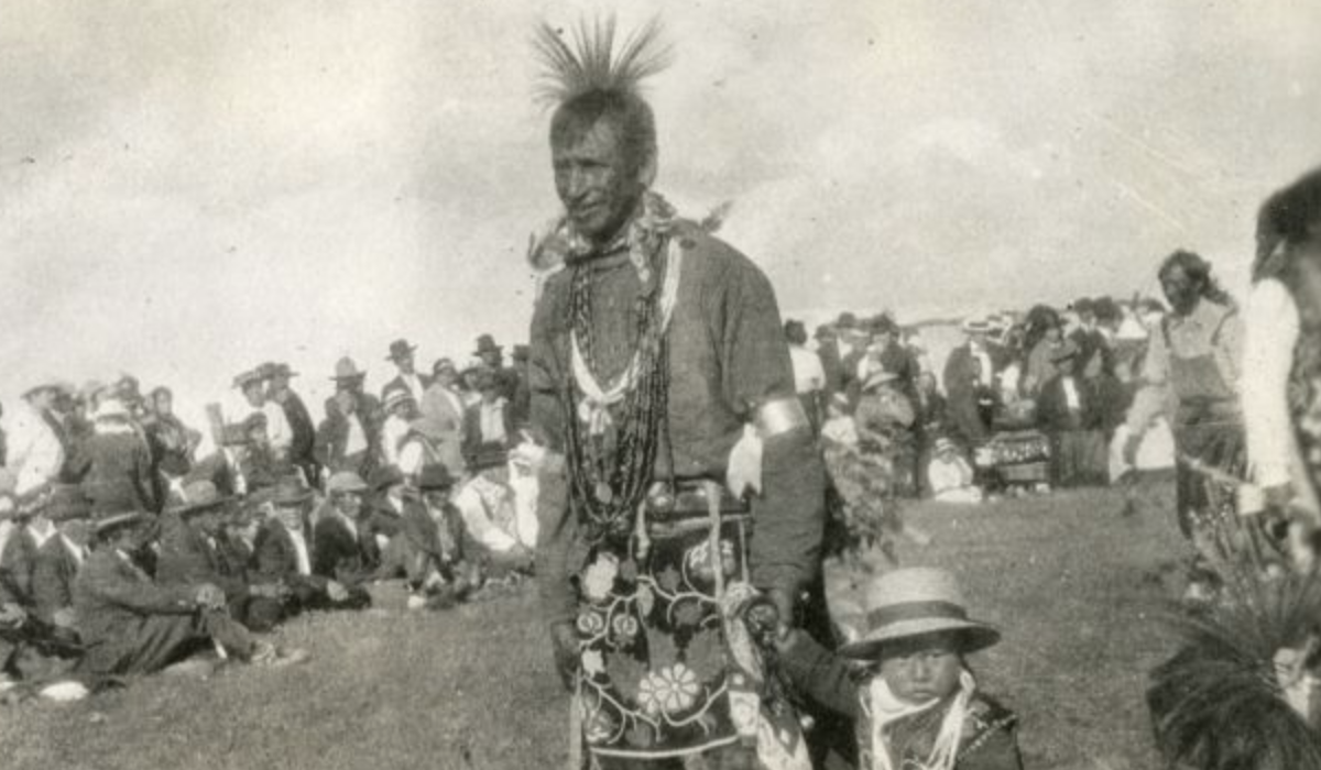 Ojibwe man and child dancing at the Annual White Earth Celebration and Pow Wow, White Earth, Minnesota