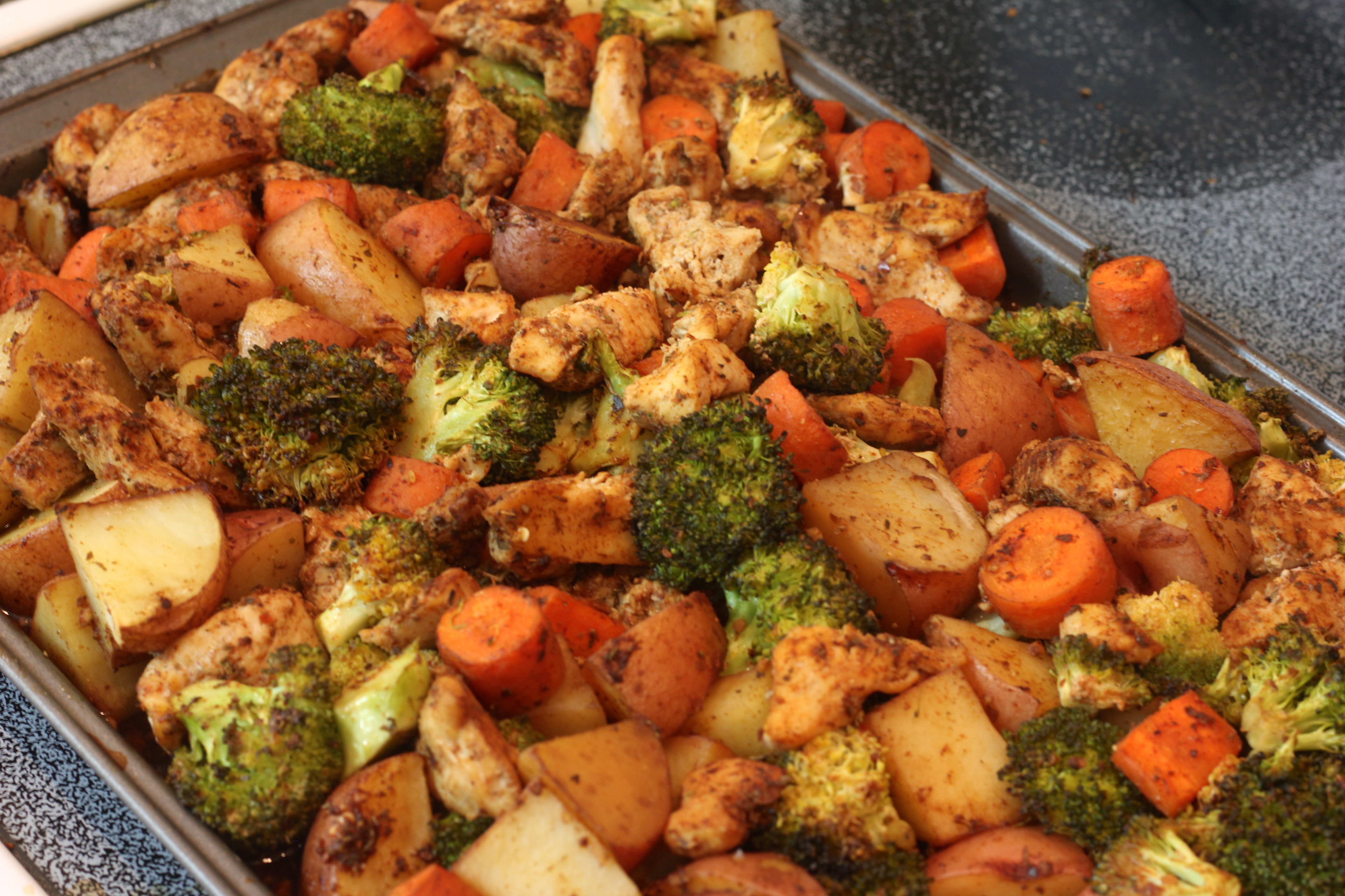 Oven baked chicken with potatoes and vegetables