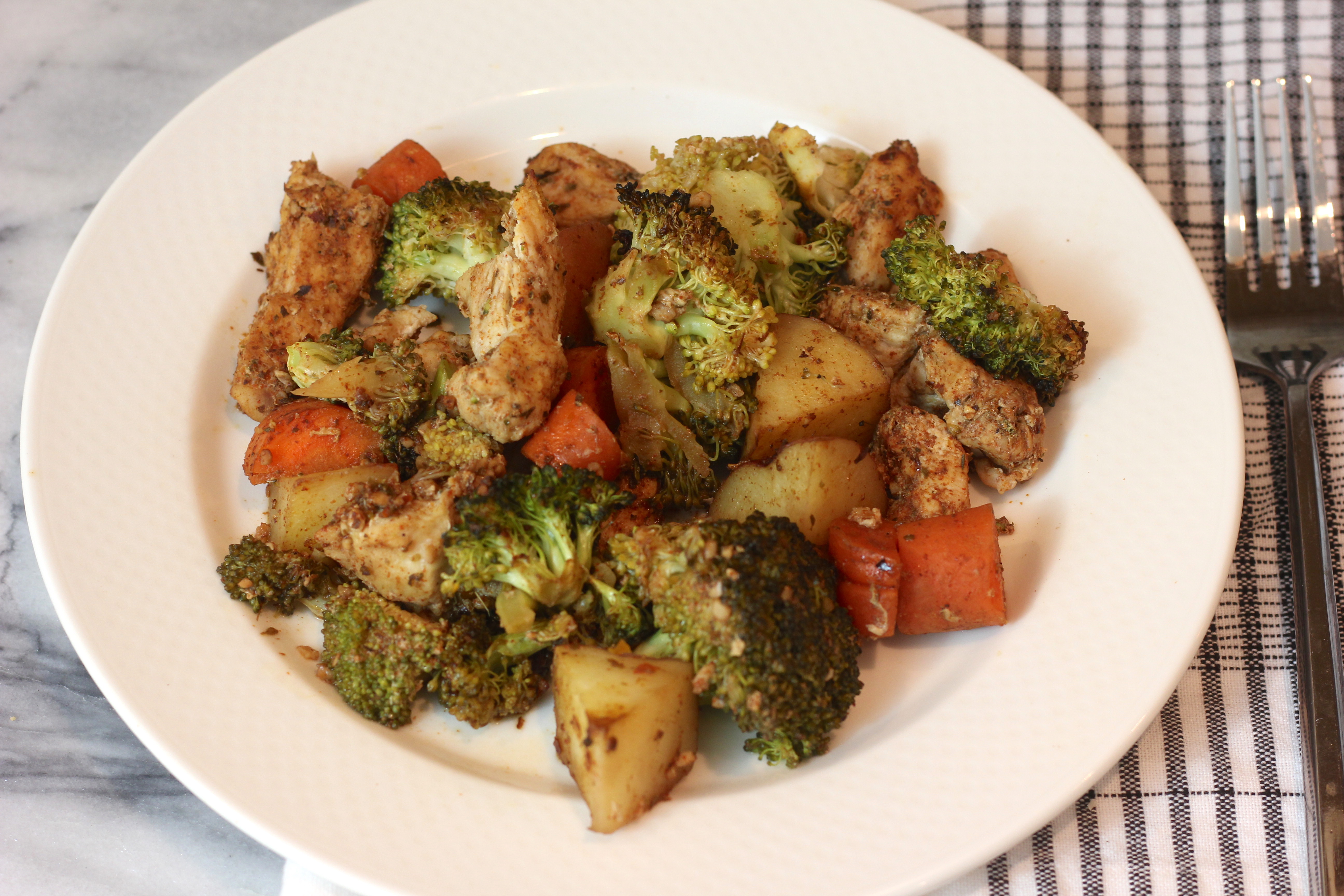 Oven baked chicken with potatoes and vegetables