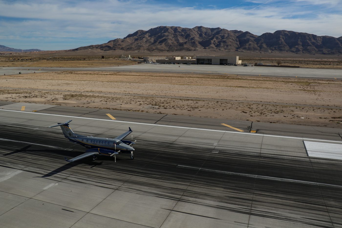 A fixed-wing aircraft prepares for takeoff on a runway.