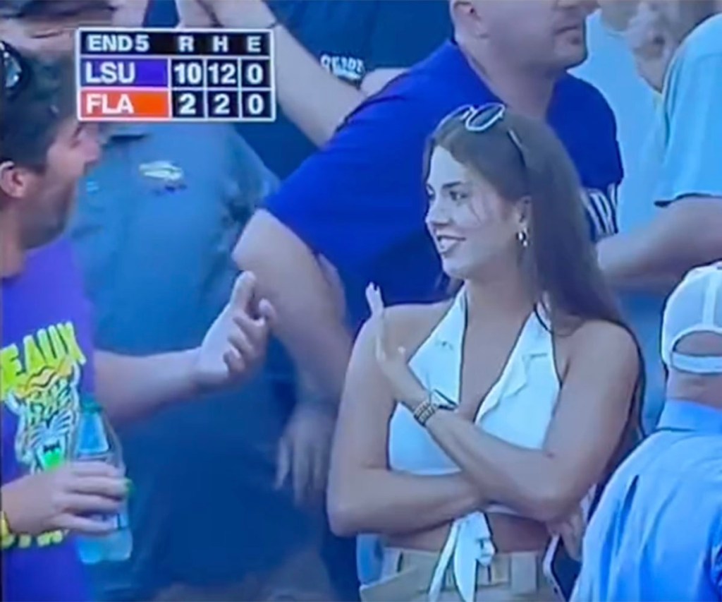 Two fans had an awkward exchange in the stands during LSU's 18-4 victory over Florida on June 26, 2023 to clinch the Men's College World Series crown. 