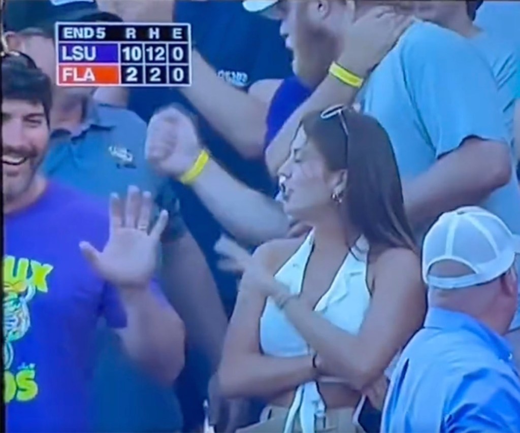 Two fans had an awkward exchange in the stands during LSU's 18-4 victory over Florida on June 26, 2023 to clinch the Men's College World Series crown. 