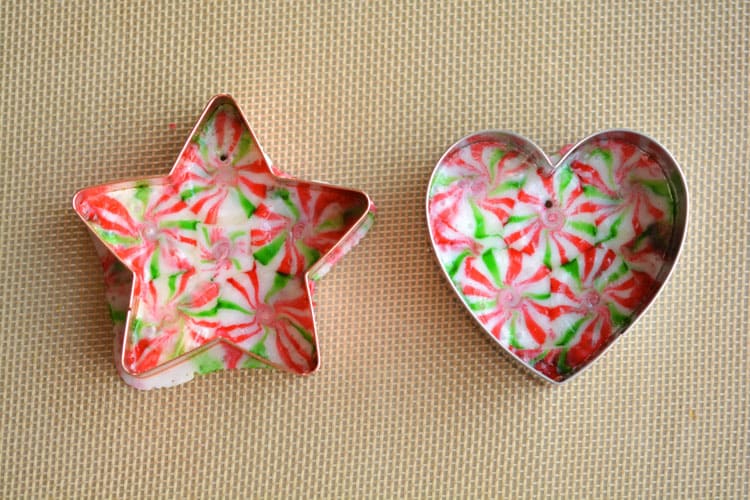 These melted peppermint candy ornaments are ADORABLE and they're super easy to make! Such a fun and inexpensive homemade Christmas ornament idea to make with the kids!