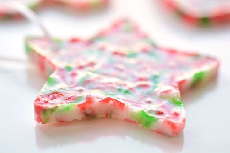 These melted peppermint candy ornaments are ADORABLE and they're super easy to make! Such a fun and inexpensive homemade Christmas ornament idea to make with the kids!