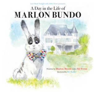 Book cover showing a white rabbit with large eyes wearing a multicolored bow-tie sitting in the grass with a large white house in the background. Above the illustration is the text 'A Day in the Life of MARLON BUNDO'.  To the right of the rabbit is the text 'Written by Marlon Bundo with Jill Twiss / Illustrated by EG Keller'.