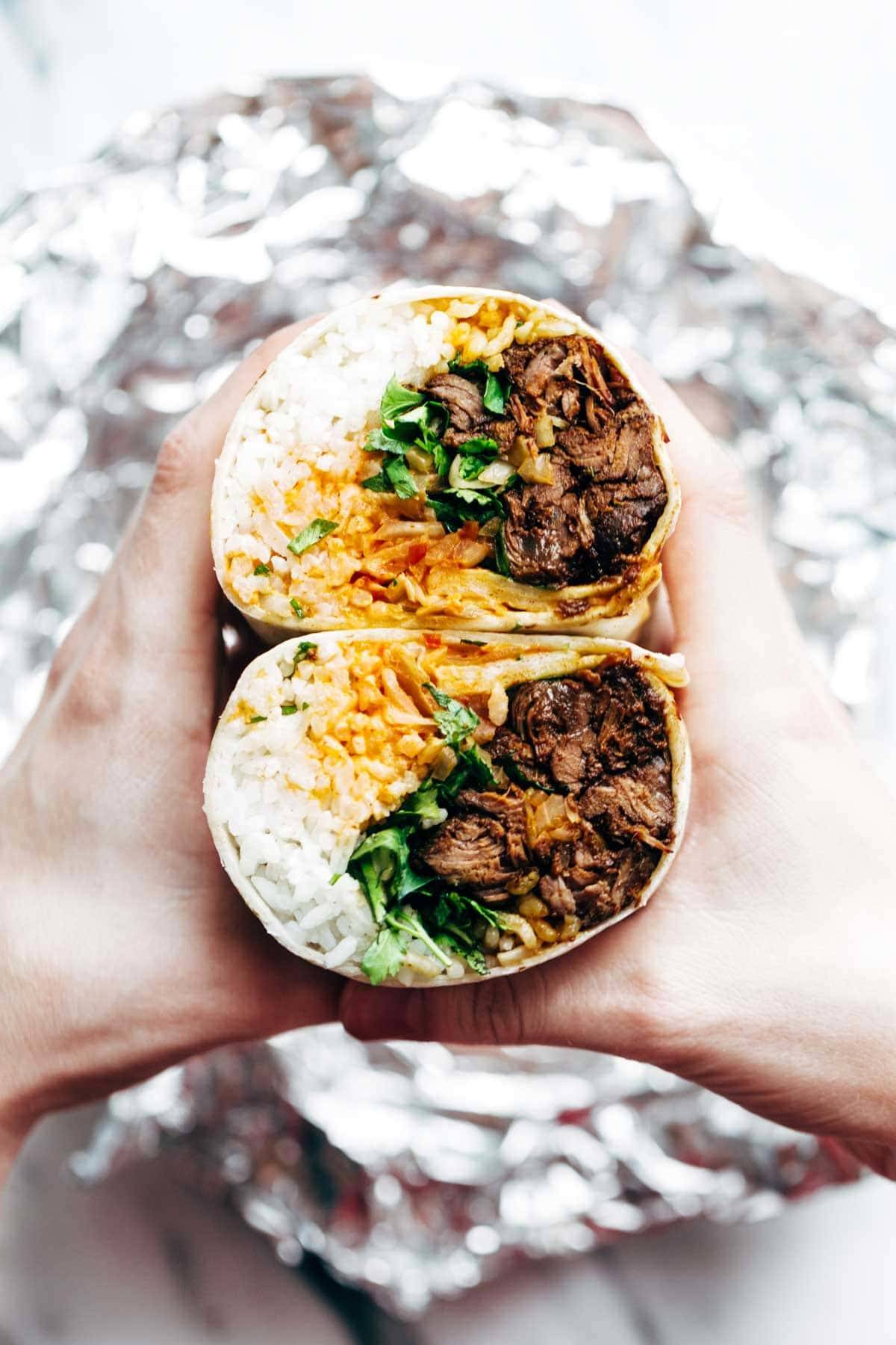 Korean BBQ Burrito - an easy food-truck-style recipe you can make with a slow cooker! spicy beef, kimchi, rice, cilantro, and sriracha mayo in a soft flour tortilla. | pinchofyum.com