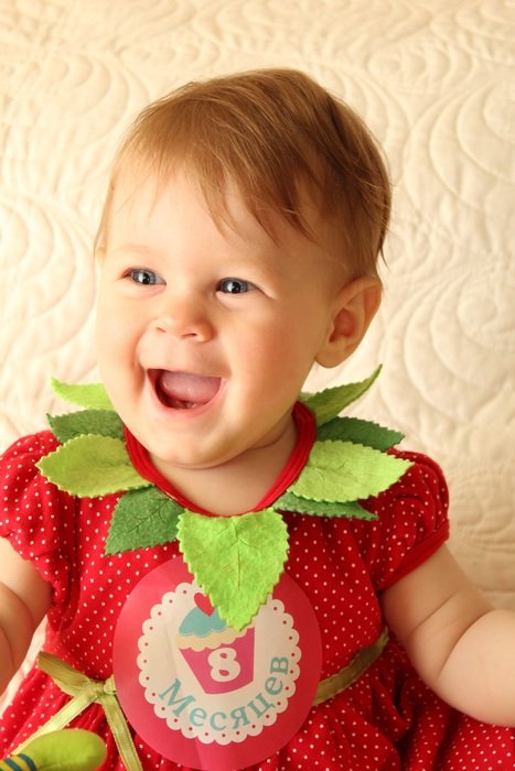 happy baby in a bright suit