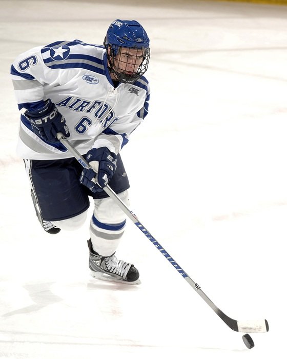 hockey player with a puck on ice