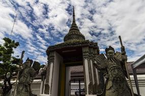 Statues near the entrance to an ancient temple in Thailand