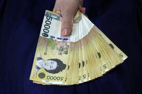 South Korean won, 50000 bills in female hand