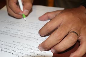 person writing with pen on paper