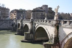 Statues standing on a stone bridge