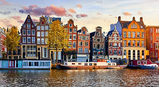 Amsterdam, The Netherlands panorama with houses and boats on the water