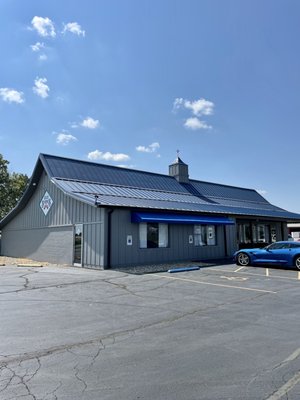 Photo of Blue Springs Cafe - Highland, IL, US. a blue car parked in front of the building