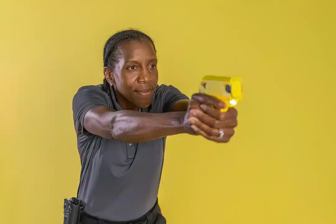 Women holding a TASER