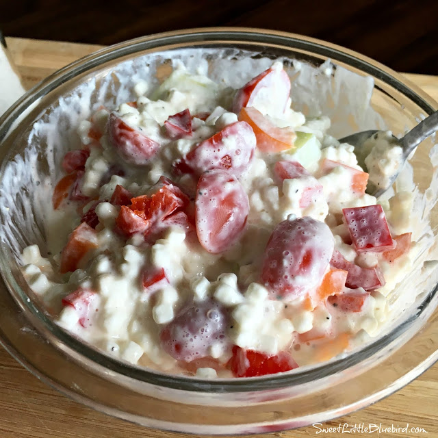 This photo show Grandma's Cottage Cheese Salad in a clear glass mixing bowl.