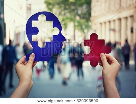 Two Hands Holding A Paper With Human Head And A Puzzle Piece. Finding A Cure To Heal The Disease. Me