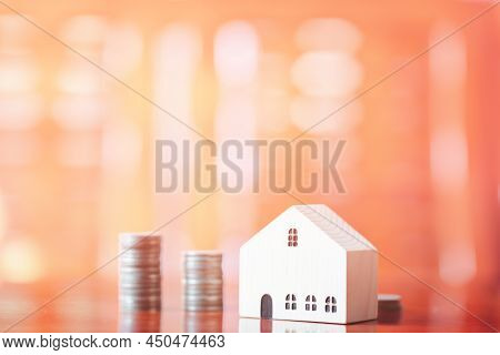 Stacks Of Coins On Desk With Green Leaf Mockup Wooden Houses, Investments, Business Growth, Saving M