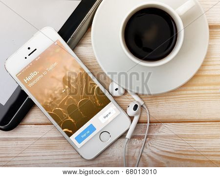 SAINT-PETERSBURG, RUSSIA - March 31, 2014: Photo of  iPhone 5 with home screen of popular social media website Twitter. iPhone 5S is a smartphone developed by Apple Inc.  