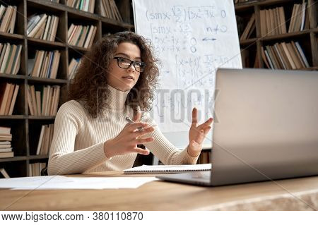 Female Young Hispanic School Math Teacher, College Tutor Coach Looking At Webcam And Talking In Clas