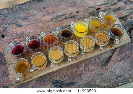 Coffee with multiple assorted types and flavors of coffee and tea in identical mugs for degustation on farm Bali island