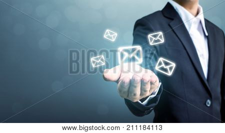 Businessman hand holding e-mail icon Contact us by newsletter email and protect your personal information from spam mail concept