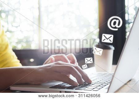 Hand Of Female Using Laptop Computer Sending E-mail Message With Email Address Symbol And Envelope I