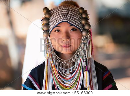 CHIANG RAI, THAILAND - DEC 4 : Akha girl with traditional clothes and silver jewelery in akha hitt tribe minority village on December 4, 2013 in Chiang Rai, Thailand. 