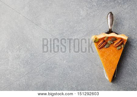 Pumpkin pie, tart made for Thanksgiving day. Grey stone background. Top view Copy space