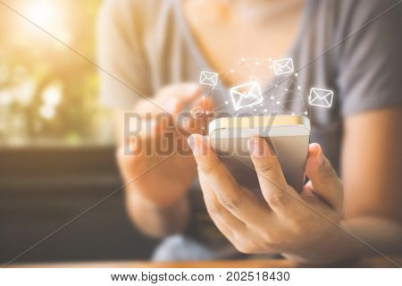 Asian woman hand using mobile phone with e-mail application Concept email and newsletter