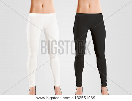 Woman wear blank leggings mockup, black, white, isolated on grey. Women in clear leggins template. Cloth pants design presentation. Sport pantaloons stretch tights model wearing. Slim legs in apparel.