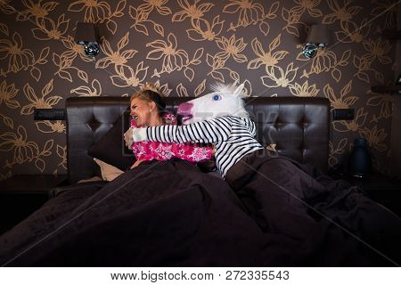 Freaky Man In Unicorn Mask Molest To Scared Girlfriend In Pajama In Bed. Unusual Couple Has Relation