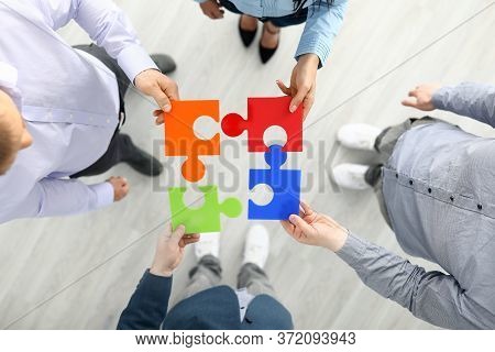 Group Businees People Hold Color Element Puzzle Top View Background Closeup. Each Fulfills Its Task 