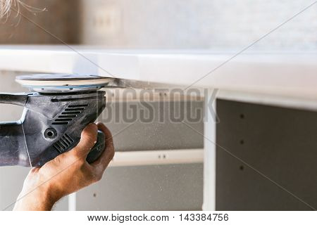 Worker Finishing Countertop From Artificial Stone