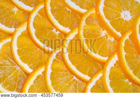 An Orange Cut Into Slices Is Lying On The Table.