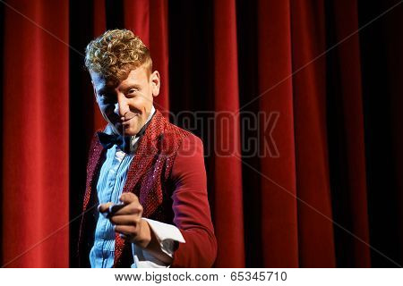 Portrait Of Anchorman At Show Against Red Curtain