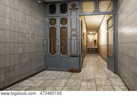 Entrance Hall Of A Vintage Residential Apartment Building With A Wooden Partition, Terrazzo Flooring