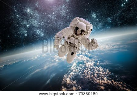 Astronaut in outer space against the backdrop of the planet earth. Elements of this image furnished by NASA.