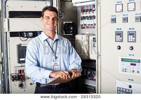 portrait of industrial engineer in front of computerized machinery