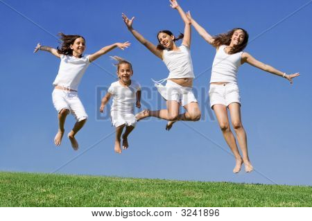 Group  Of Happy Kids Jumping For Joy